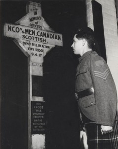 Staff Sergeant Doidge, in an original 16th Battalion uniform, stands before the Vimy Cross once at Pioneer Square.